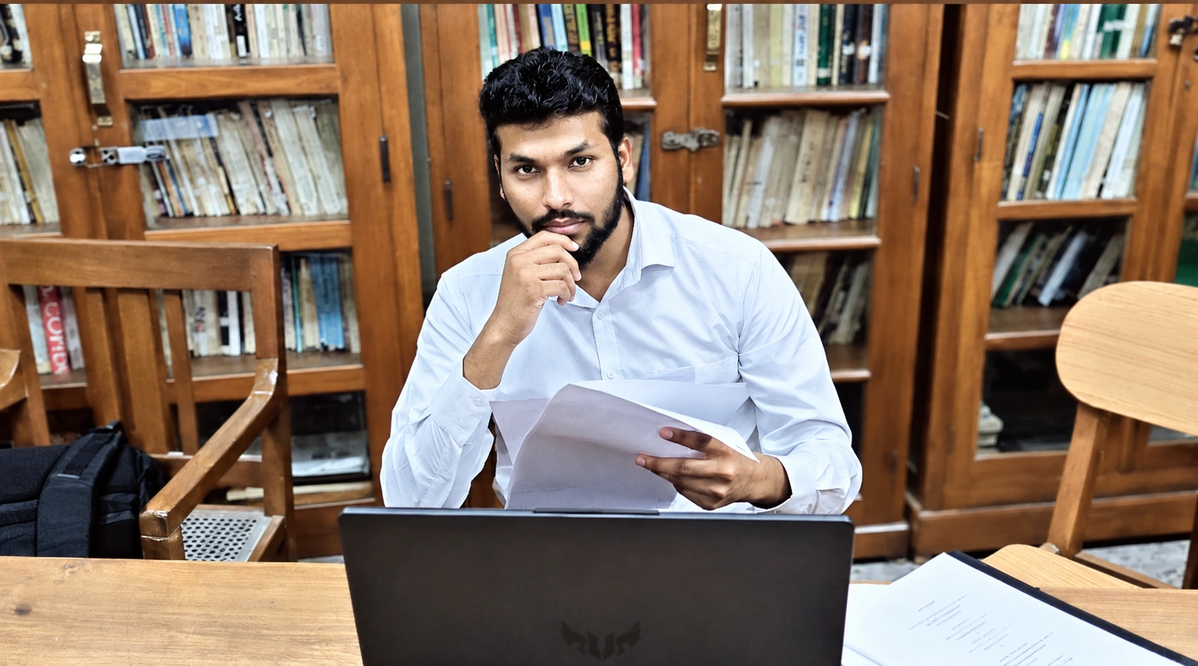 Syed Masthan seated at a library desk